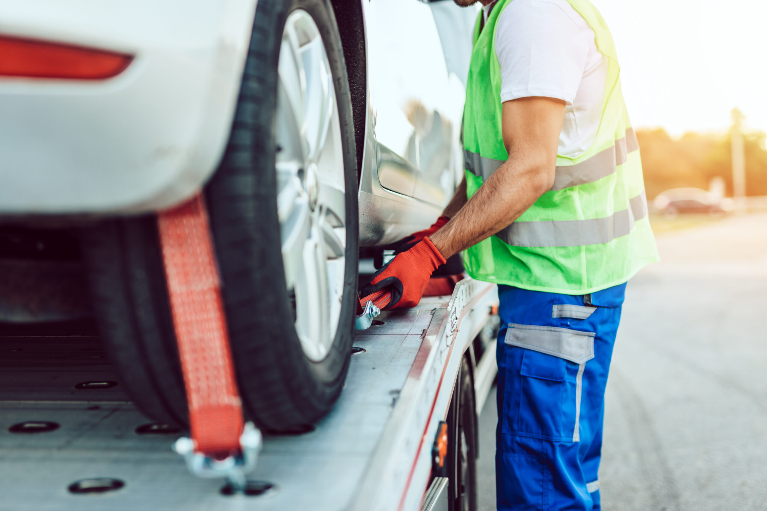 Handsome middle age man working in towing service on the road. R
