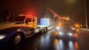 Lifting container on trailer for heavy-duty recovery.